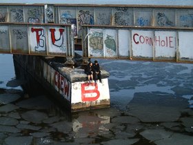 couple sitting on a bridge pylon